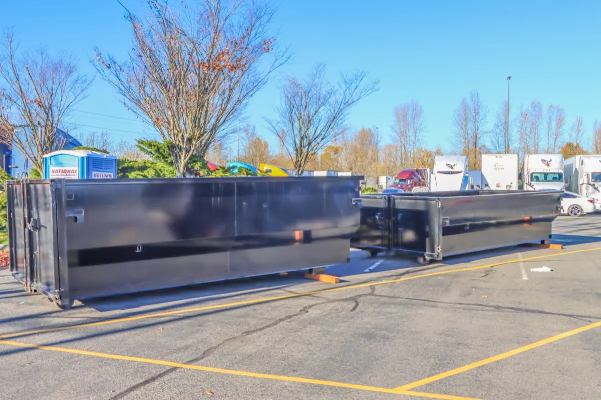Professional dumpster rental service with roll-off container on residential driveway in Olive Branch